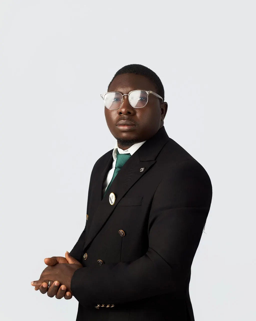 An Astracrest team member in a black suit and green tie