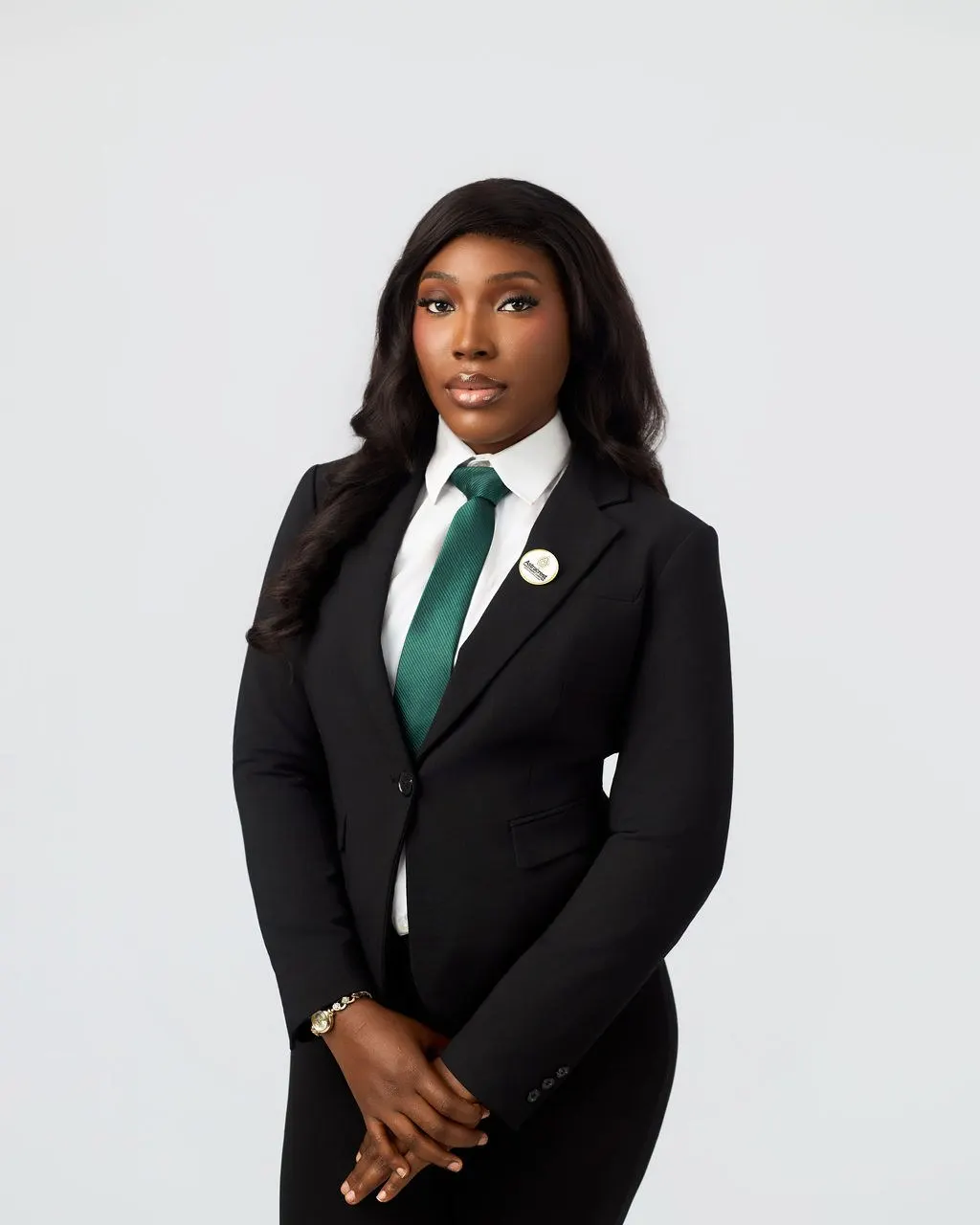 An Astracrest team member in a black suit and green tie