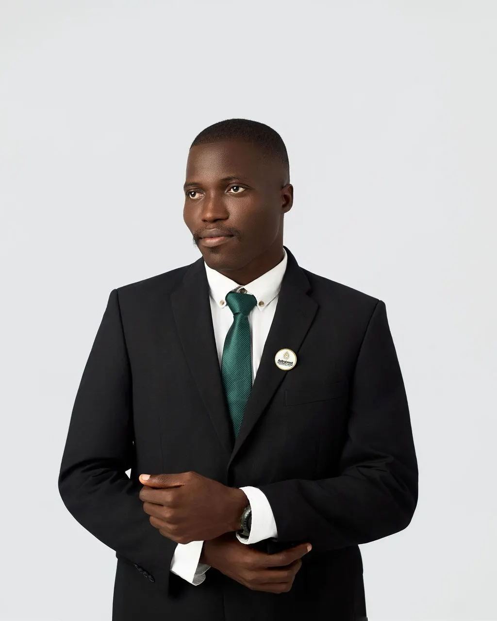 An Astracrest team member in a black suit and green tie