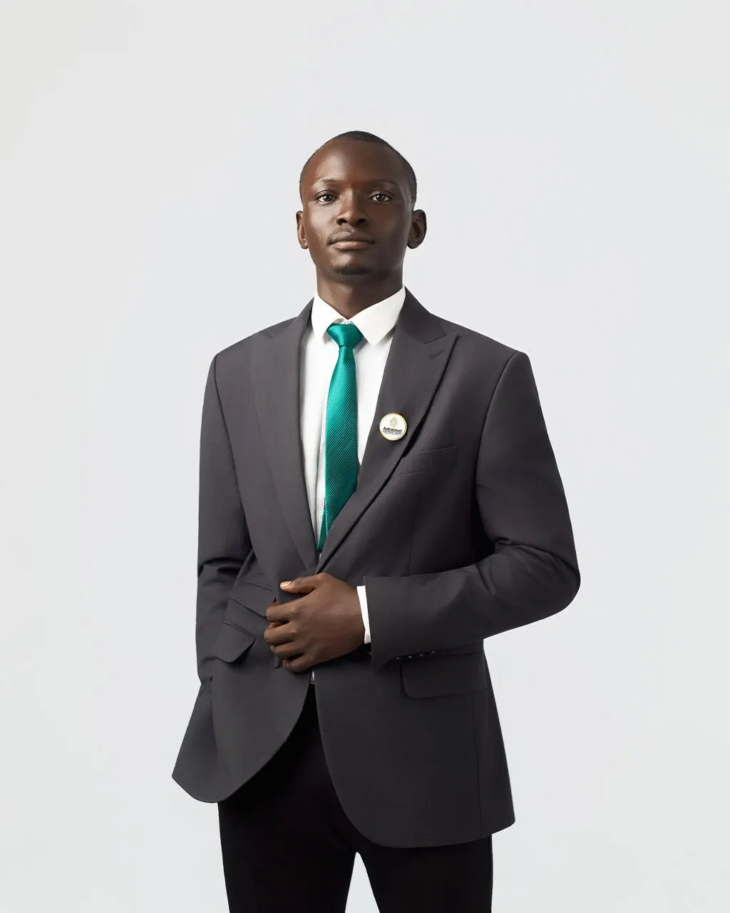 An Astracrest team member in a black suit and green tie