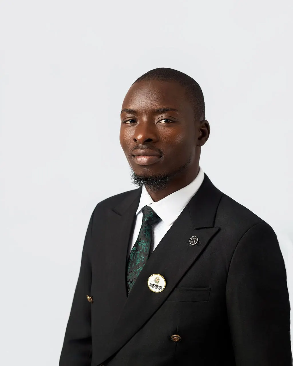 An Astracrest team member in a black suit and green tie