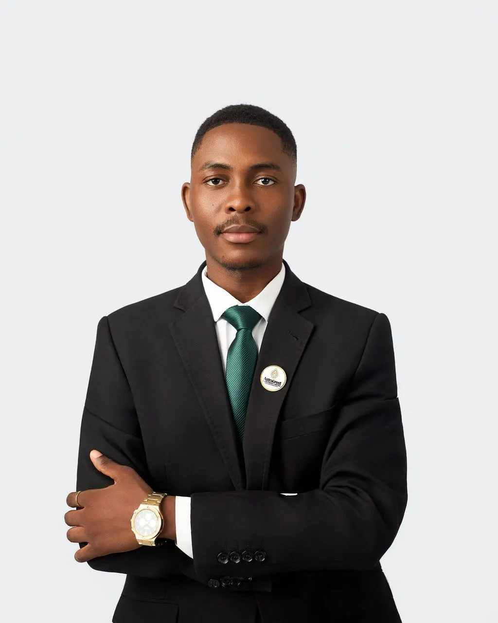 An Astracrest team member in a black suit and green tie
