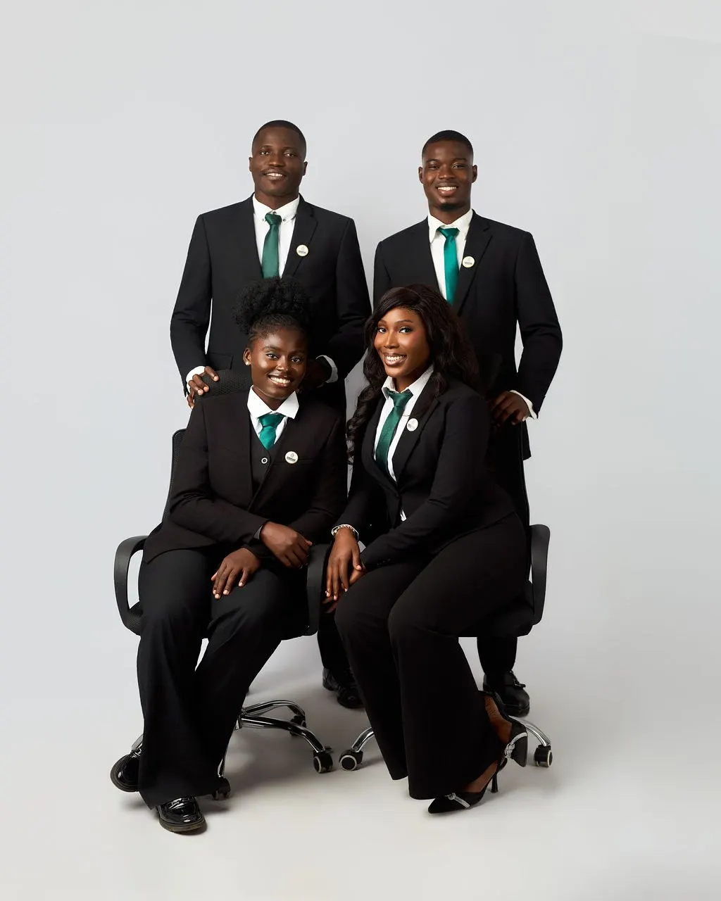 Four members of the Astracrest team, two seated and two standing