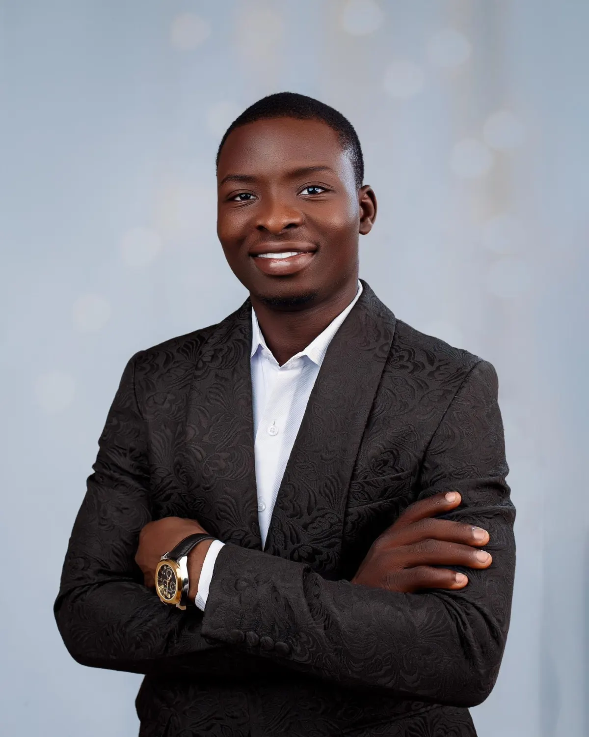 AdeJare Michael Adetomiwa, Founder and Managing Director of Astracrest, smiling with arms folded