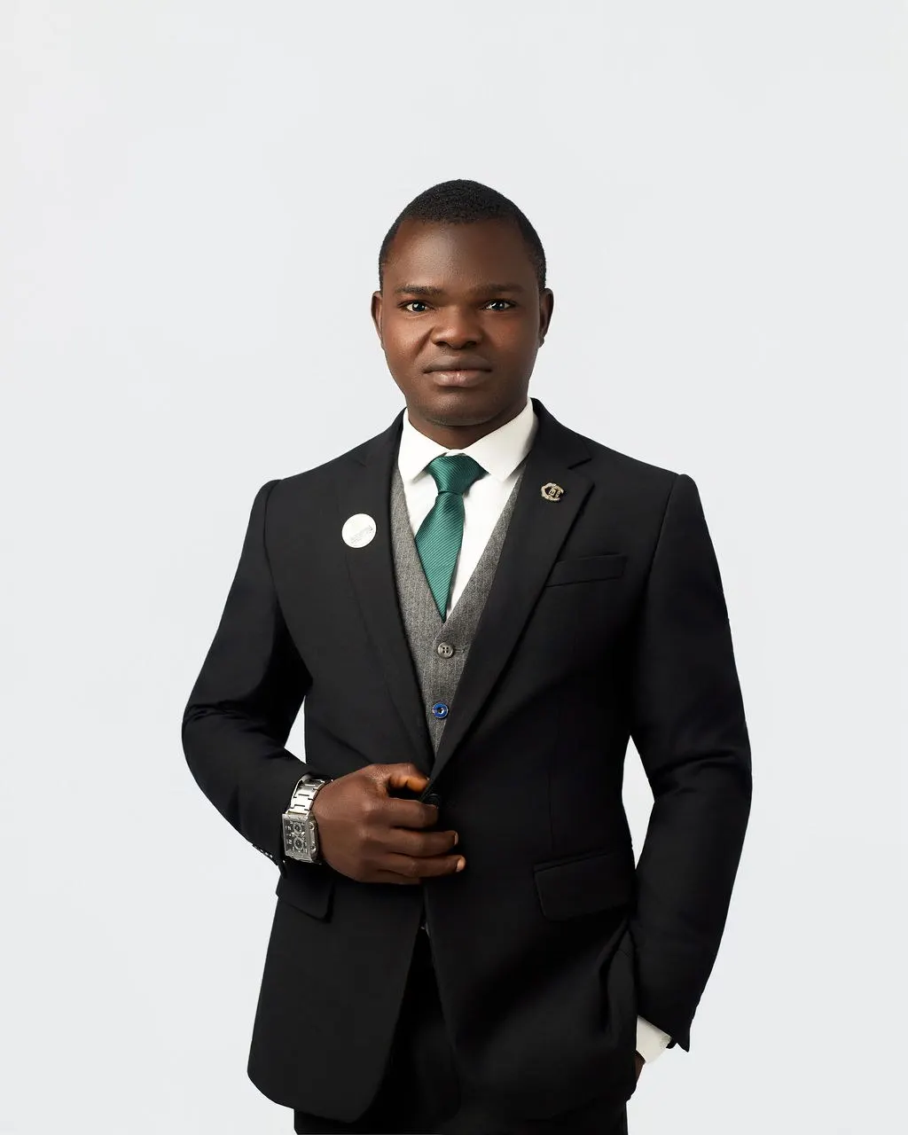 An Astracrest team member in a black suit and green tie