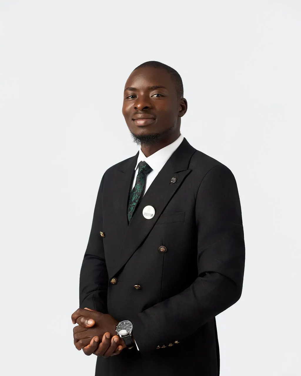 An Astracrest team member in a black suit and green tie