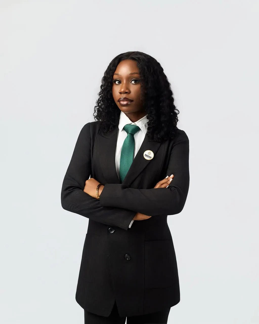 An Astracrest team member in a black suit and green tie